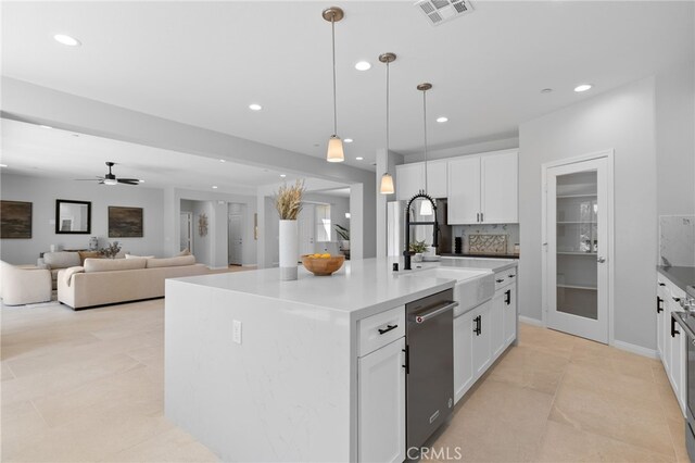kitchen featuring recessed lighting, visible vents, stainless steel dishwasher, a sink, and white cabinetry