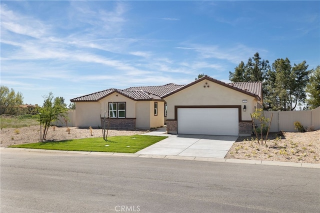 ranch-style house with a tiled roof, driveway, fence, a garage, and stucco siding
