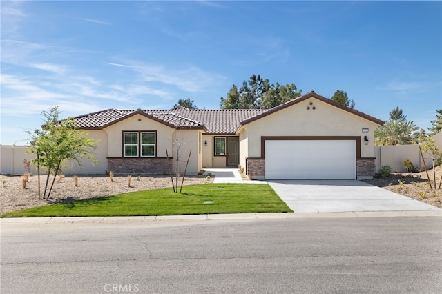 view of front facade with a garage, driveway, fence, a front yard, and stucco siding
