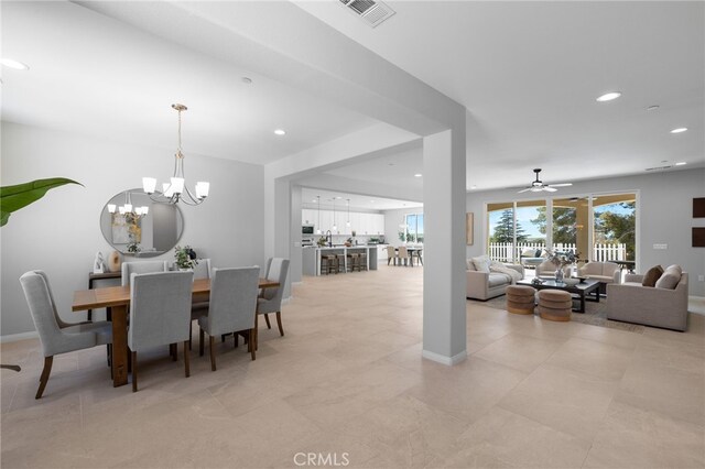 dining room with ceiling fan with notable chandelier, baseboards, visible vents, and recessed lighting