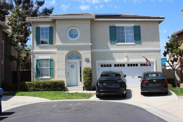 4730 Milano Way, Oceanside, CA 92057 - traditional-style house with stucco siding, driveway, roof mounted solar panels, and a garage