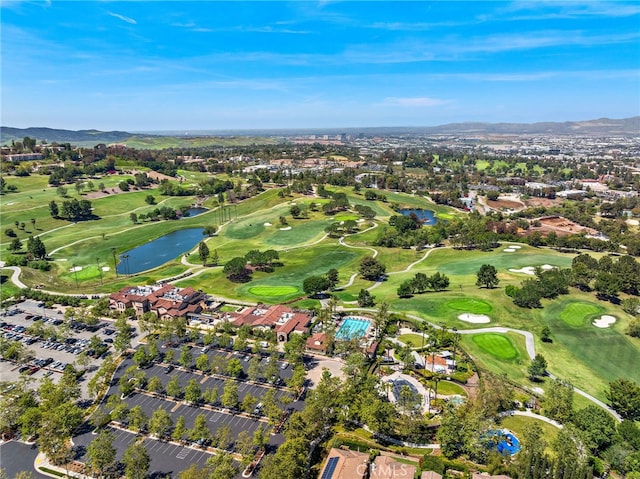 drone / aerial view featuring golf course view and a water and mountain view