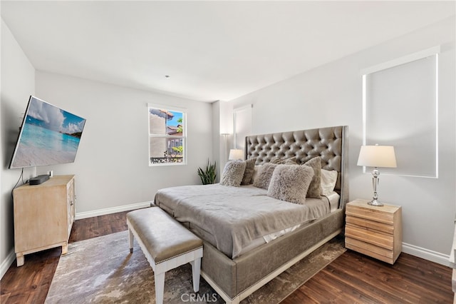 bedroom with baseboards and wood finished floors