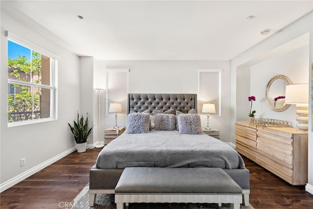 bedroom with wood finished floors and baseboards