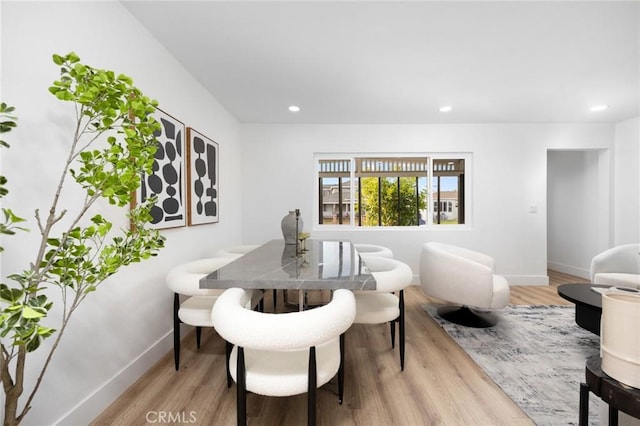 dining room with recessed lighting, wood finished floors, and baseboards