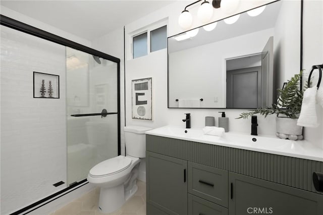 full bathroom with a shower stall, tile patterned flooring, double vanity, toilet, and a sink