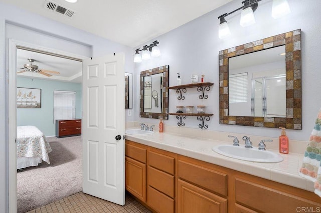 bathroom with visible vents, ensuite bathroom, a shower stall, and a sink