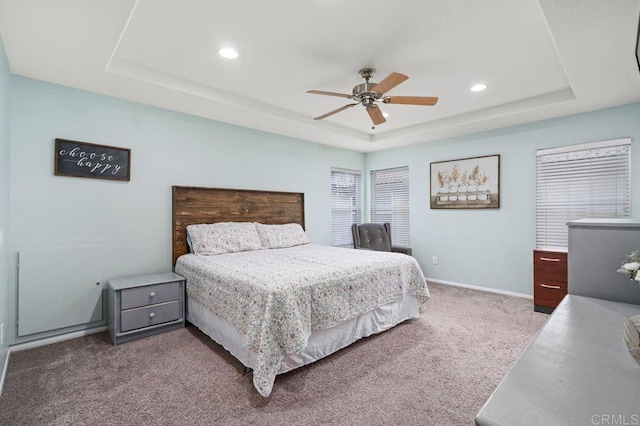 bedroom featuring recessed lighting, a tray ceiling, baseboards, carpet flooring, and ceiling fan