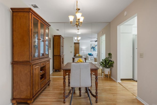 1038 Eider Way, Oceanside, CA 92057 - dining space with visible vents, light wood-style floors, baseboards, and a notable chandelier