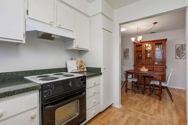 1038 Eider Way, Oceanside, CA 92057 - kitchen with electric stove, under cabinet range hood, a chandelier, and dark countertops