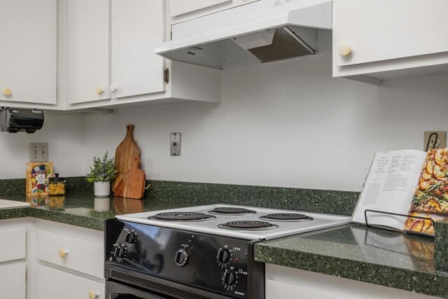 1038 Eider Way, Oceanside, CA 92057 - kitchen featuring custom exhaust hood, range with electric cooktop, white cabinets, and dark countertops