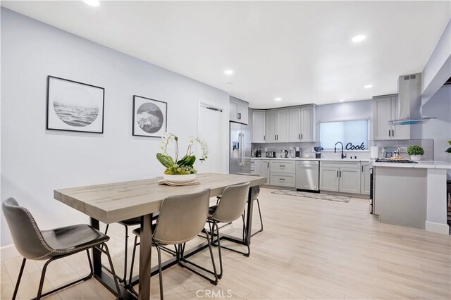 dining space featuring recessed lighting and light wood-type flooring