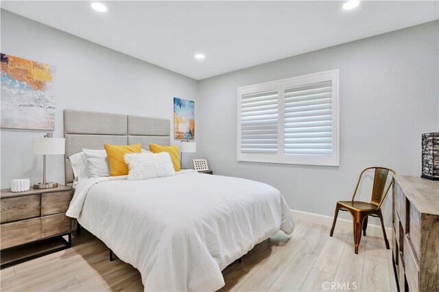 bedroom with recessed lighting, wood finished floors, and baseboards