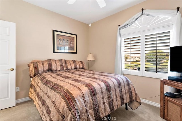 carpeted bedroom featuring a ceiling fan and baseboards