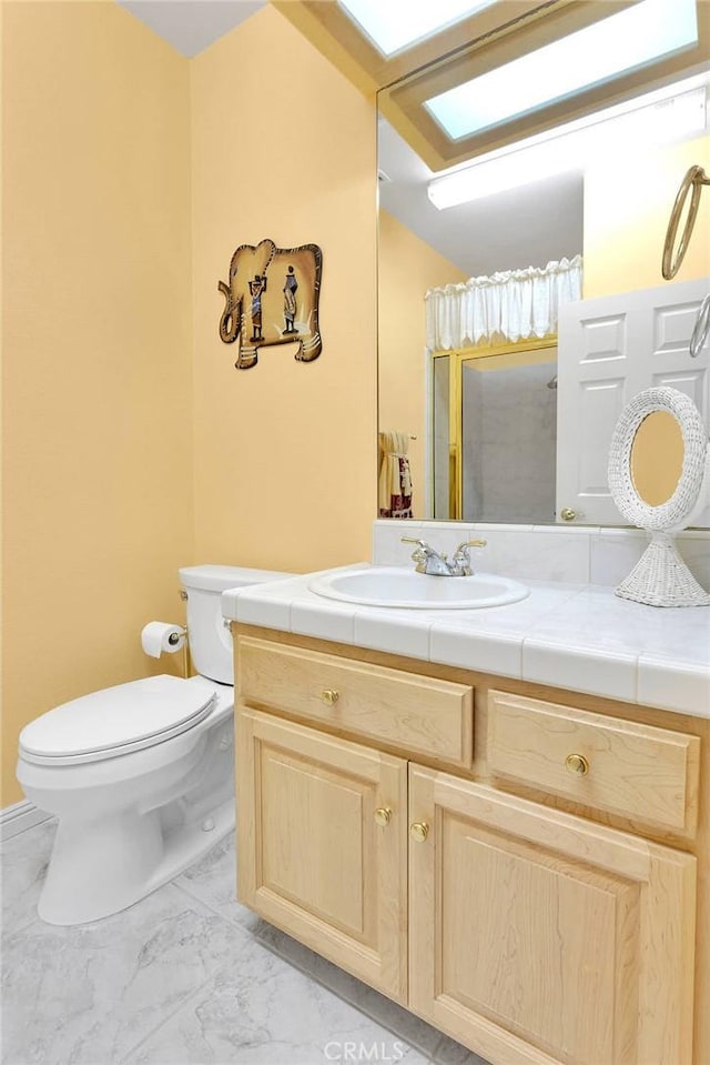 full bathroom with a shower, marble finish floor, vanity, and toilet