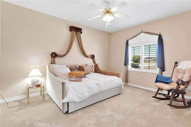 carpeted bedroom featuring baseboards and a ceiling fan