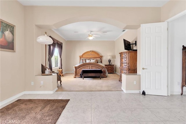 bedroom featuring crown molding, arched walkways, carpet, baseboards, and tile patterned flooring