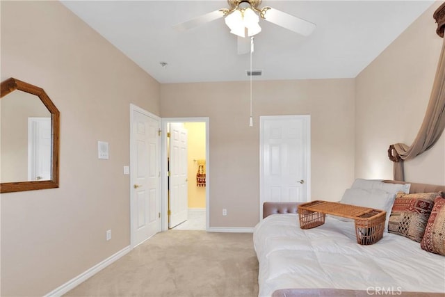 bedroom with ensuite bathroom, ceiling fan, light carpet, baseboards, and visible vents