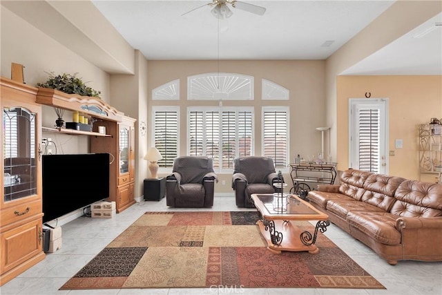 living area featuring a ceiling fan and light tile patterned floors
