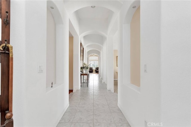hallway featuring arched walkways