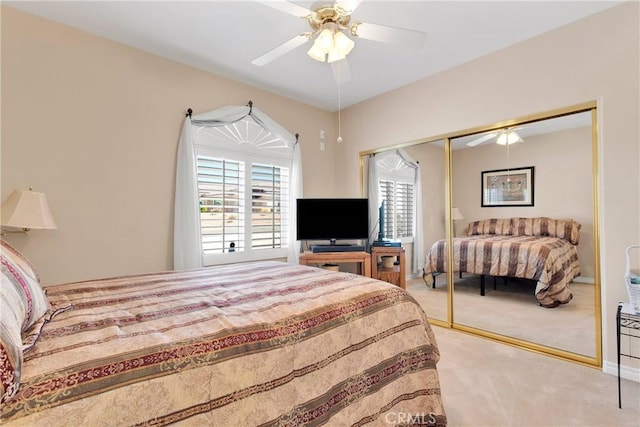 bedroom with a ceiling fan, a closet, and carpet