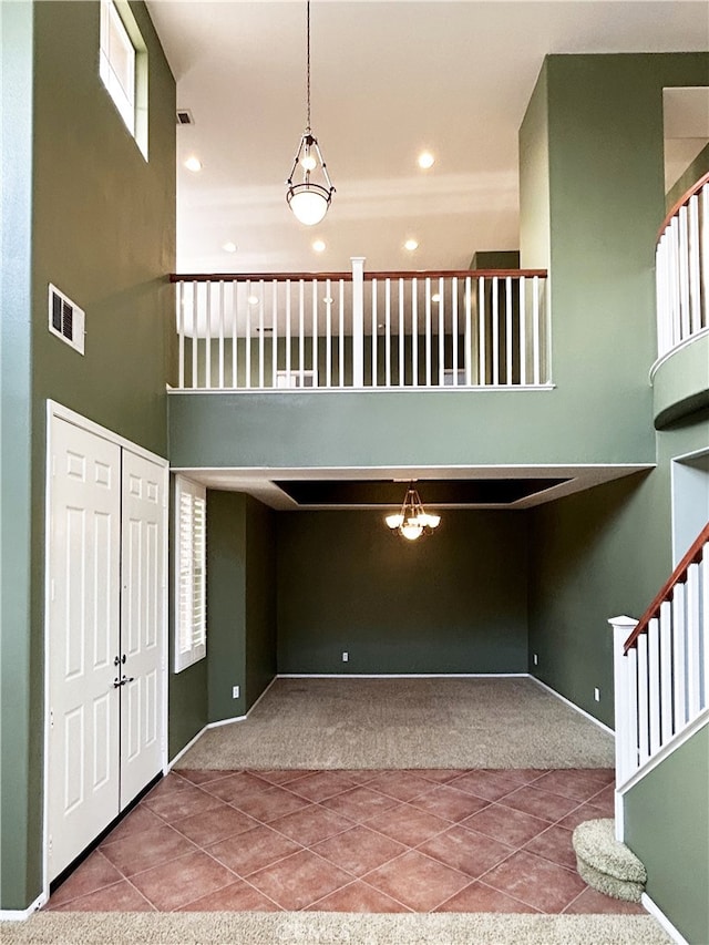 5743 Kendall Ct, Rancho Cucamonga, CA 91739 - carpeted foyer with stairs, tile patterned floors, a towering ceiling, baseboards, and recessed lighting