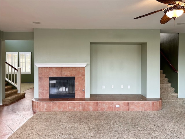 5743 Kendall Ct, Rancho Cucamonga, CA 91739 - unfurnished living room with stairway, a tile fireplace, a ceiling fan, and tile patterned floors
