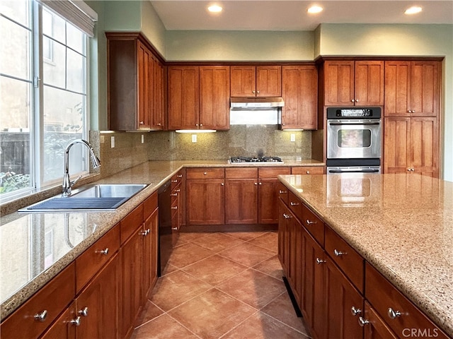 5743 Kendall Ct, Rancho Cucamonga, CA 91739 - kitchen with a sink, under cabinet range hood, gas stovetop, double oven, and decorative backsplash
