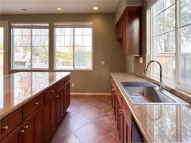 5743 Kendall Ct, Rancho Cucamonga, CA 91739 - kitchen with a sink, baseboards, recessed lighting, brown cabinets, and decorative backsplash