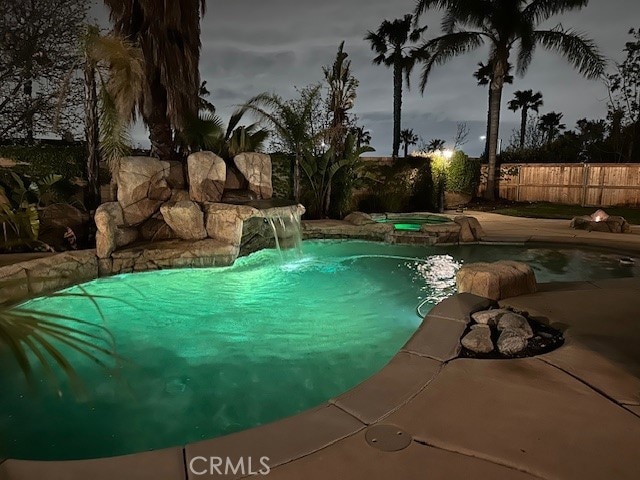 5743 Kendall Ct, Rancho Cucamonga, CA 91739 - view of swimming pool with fence, a pool with connected hot tub, and a patio