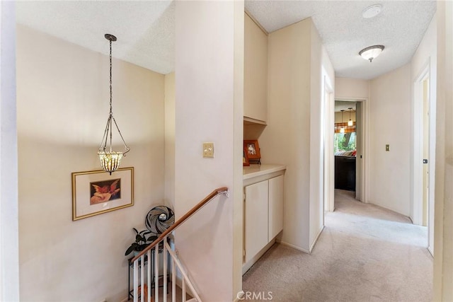 19852 Pandy Ct, Canyon Country, CA 91351 - corridor with light colored carpet, an upstairs landing, and a textured ceiling