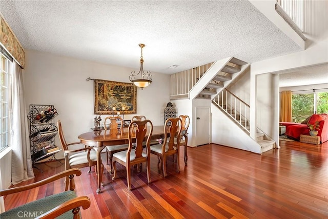 19852 Pandy Ct, Canyon Country, CA 91351 - dining space with wood finished floors, a textured ceiling, and stairs