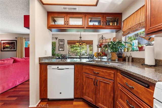 19852 Pandy Ct, Canyon Country, CA 91351 - kitchen with wood finished floors, a sink, brown cabinets, dishwasher, and visible vents