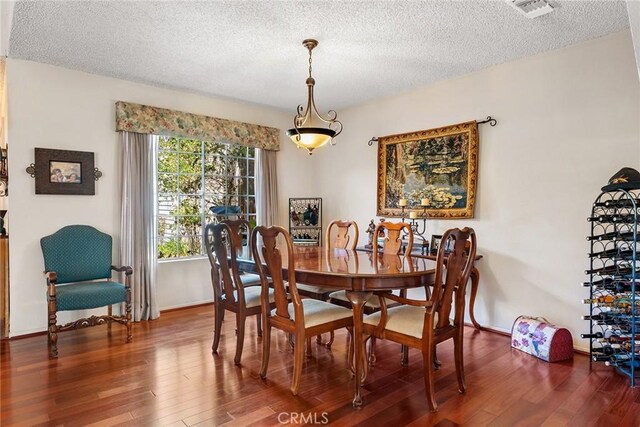 19852 Pandy Ct, Canyon Country, CA 91351 - dining space with a textured ceiling, wood finished floors, visible vents, and baseboards