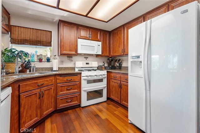 19852 Pandy Ct, Canyon Country, CA 91351 - kitchen with brown cabinets, dark wood finished floors, a sink, and white appliances