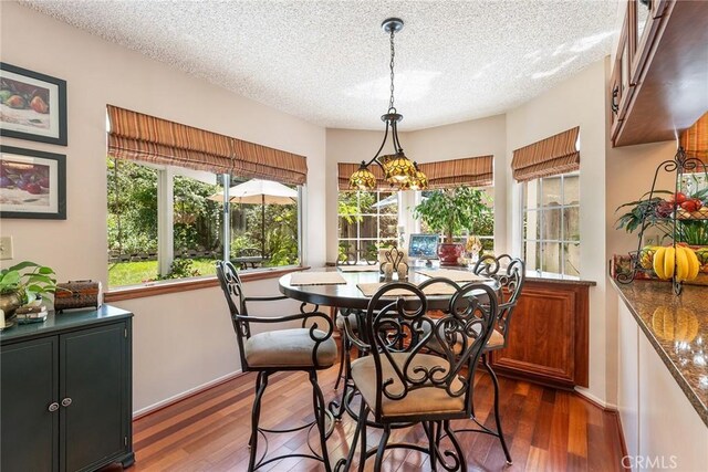 19852 Pandy Ct, Canyon Country, CA 91351 - dining room featuring baseboards, dark wood-type flooring, and a textured ceiling