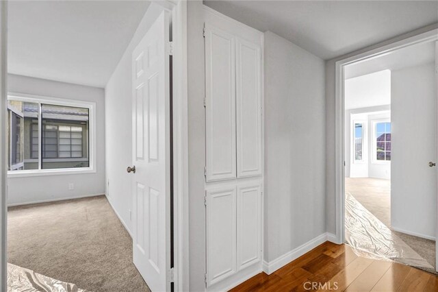 18324 Clark St Unit 315, Tarzana, CA 91356 - hallway featuring wood finished floors and baseboards