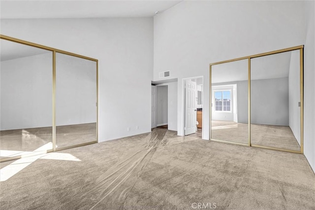 18324 Clark St Unit 315, Tarzana, CA 91356 - unfurnished bedroom with visible vents, multiple closets, carpet flooring, and high vaulted ceiling