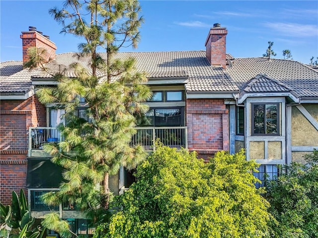 18324 Clark St Unit 315, Tarzana, CA 91356 - rear view of property featuring a chimney and brick siding