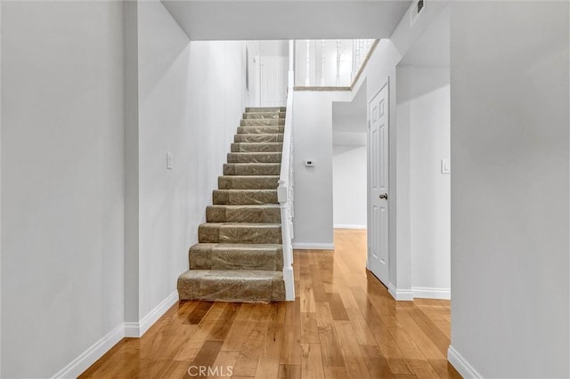 18324 Clark St Unit 315, Tarzana, CA 91356 - stairs with baseboards, wood finished floors, and visible vents