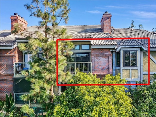 18324 Clark St Unit 315, Tarzana, CA 91356 - back of house with a chimney, a tile roof, and brick siding