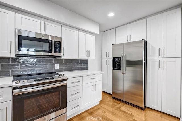 18324 Clark St Unit 315, Tarzana, CA 91356 - kitchen with white cabinets, light countertops, and appliances with stainless steel finishes