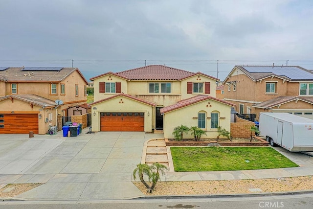 mediterranean / spanish-style home with concrete driveway, a tiled roof, fence, stucco siding, and a residential view