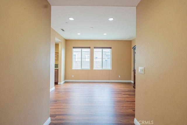 spare room with visible vents, baseboards, wood finished floors, and recessed lighting