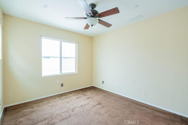 unfurnished room with baseboards, a ceiling fan, visible vents, and carpet flooring