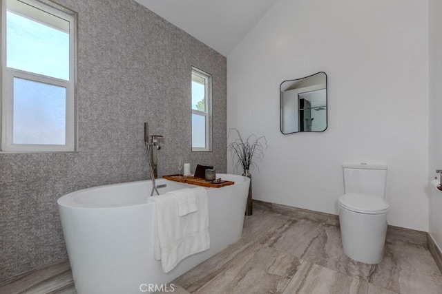 4738 E Fairfield St, Anaheim Hills, CA 92807 - bathroom featuring vaulted ceiling, toilet, a freestanding tub, and baseboards