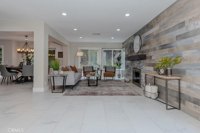 4738 E Fairfield St, Anaheim Hills, CA 92807 - living area with recessed lighting, a chandelier, a fireplace, an accent wall, and wooden walls