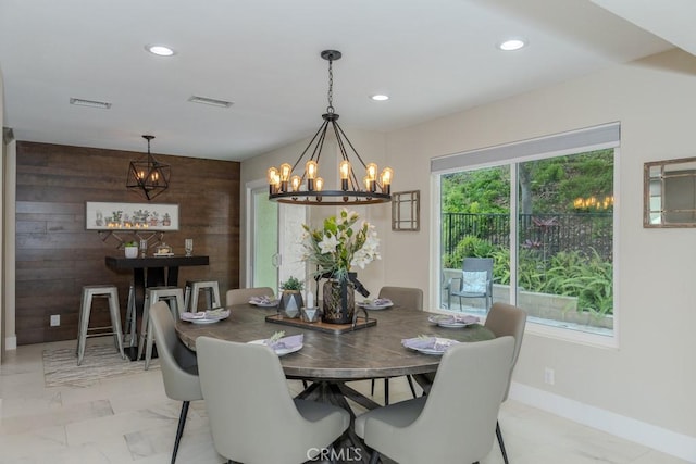 4738 E Fairfield St, Anaheim Hills, CA 92807 - dining space with light marble finish flooring, a chandelier, wood walls, recessed lighting, and baseboards