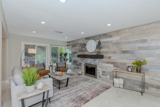 4738 E Fairfield St, Anaheim Hills, CA 92807 - living room with marble look tiles, recessed lighting, and a stone fireplace