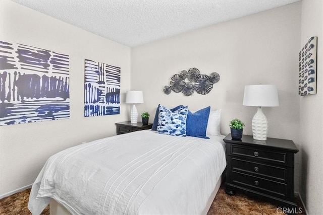 bedroom with a textured ceiling and carpet flooring